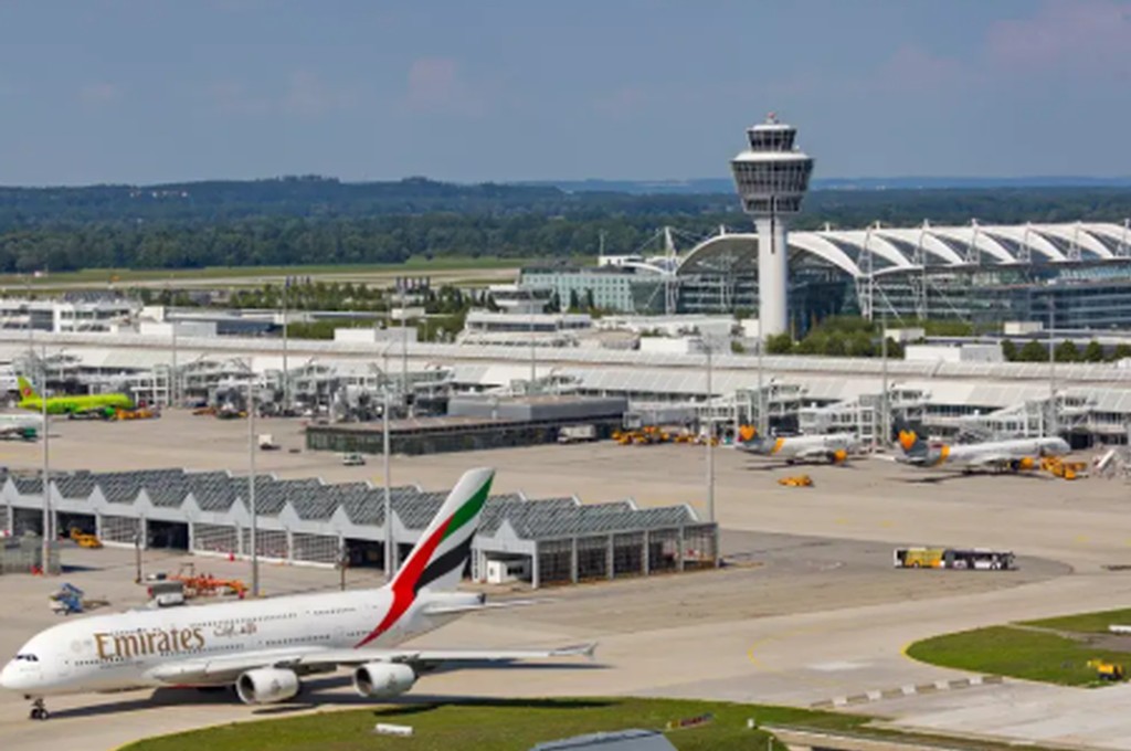 Terminal exterior and airport signs at Munich Airport in Germany.