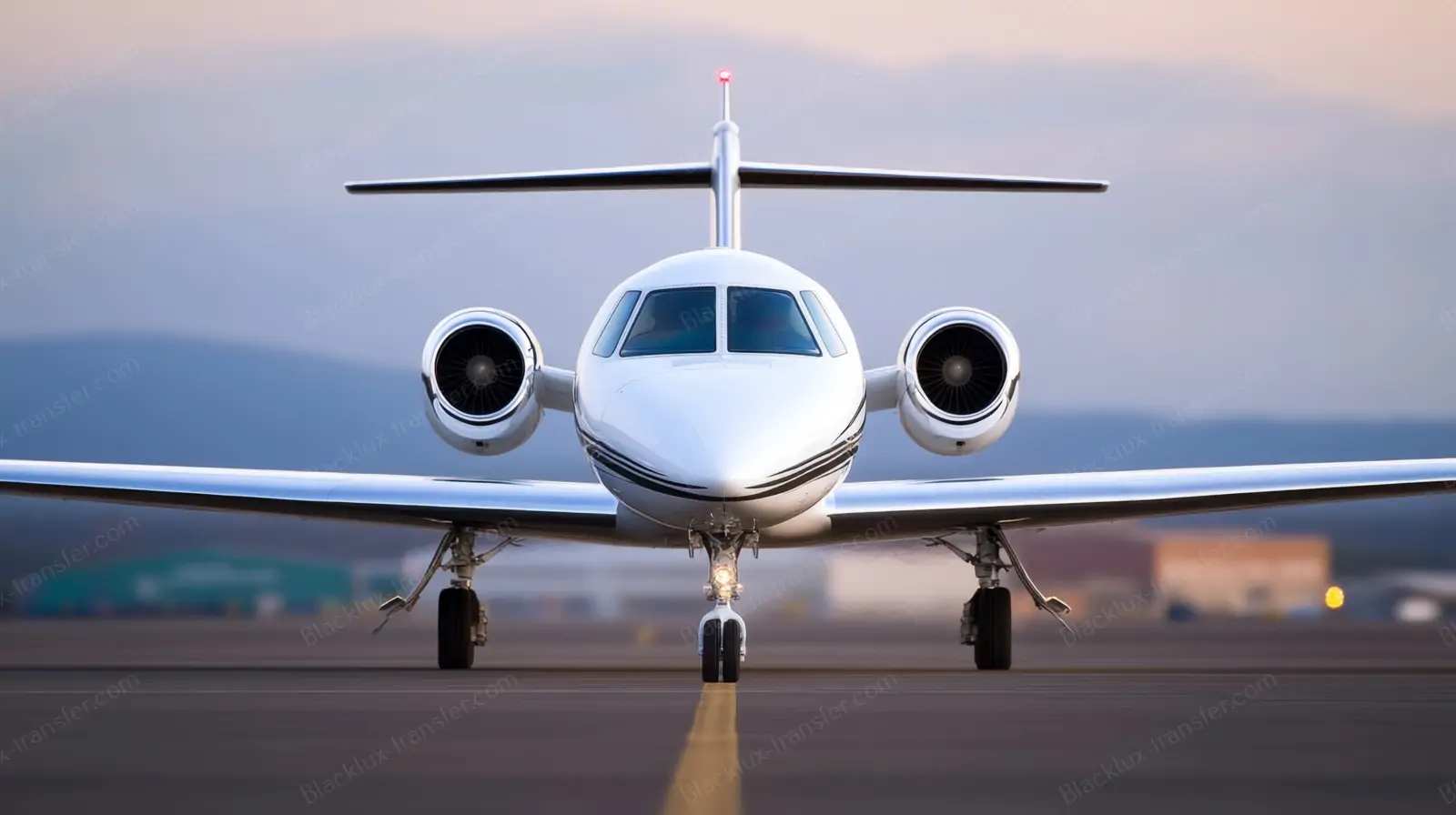 White private jet viewed from the front on an airport apron